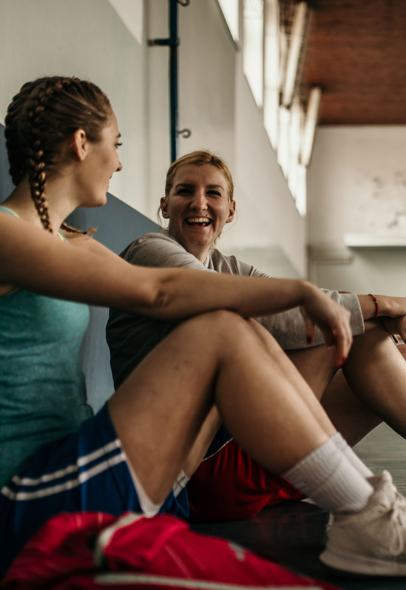 Young basketball players sitting and laughing on the sidelines