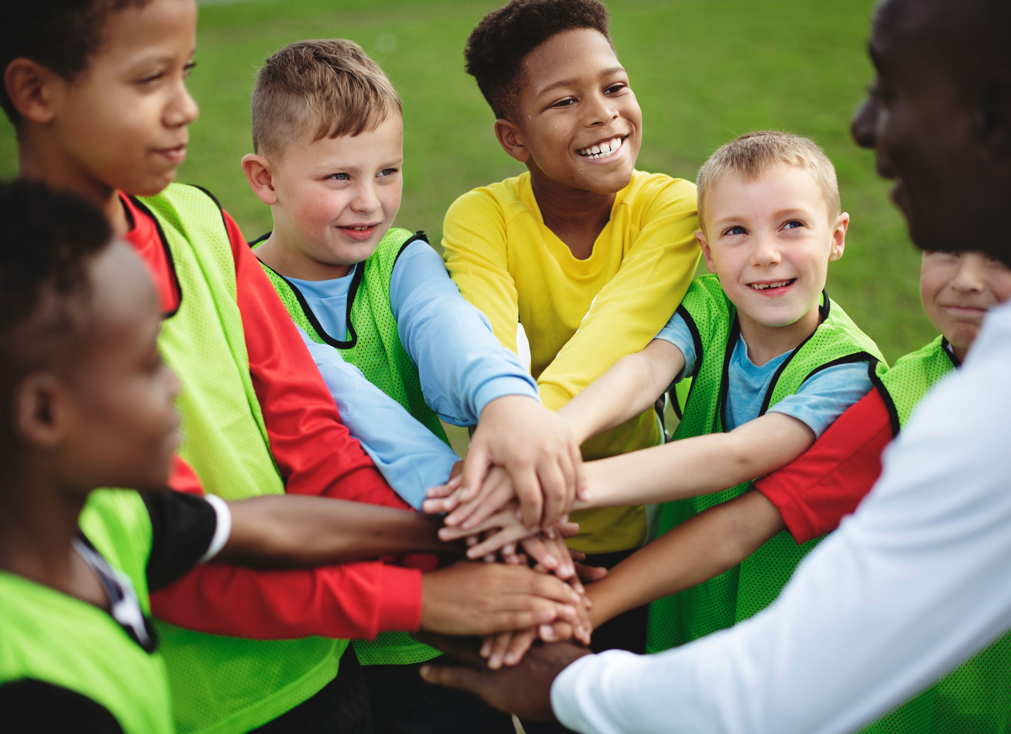 Young players huddling up for a pre-game hooray